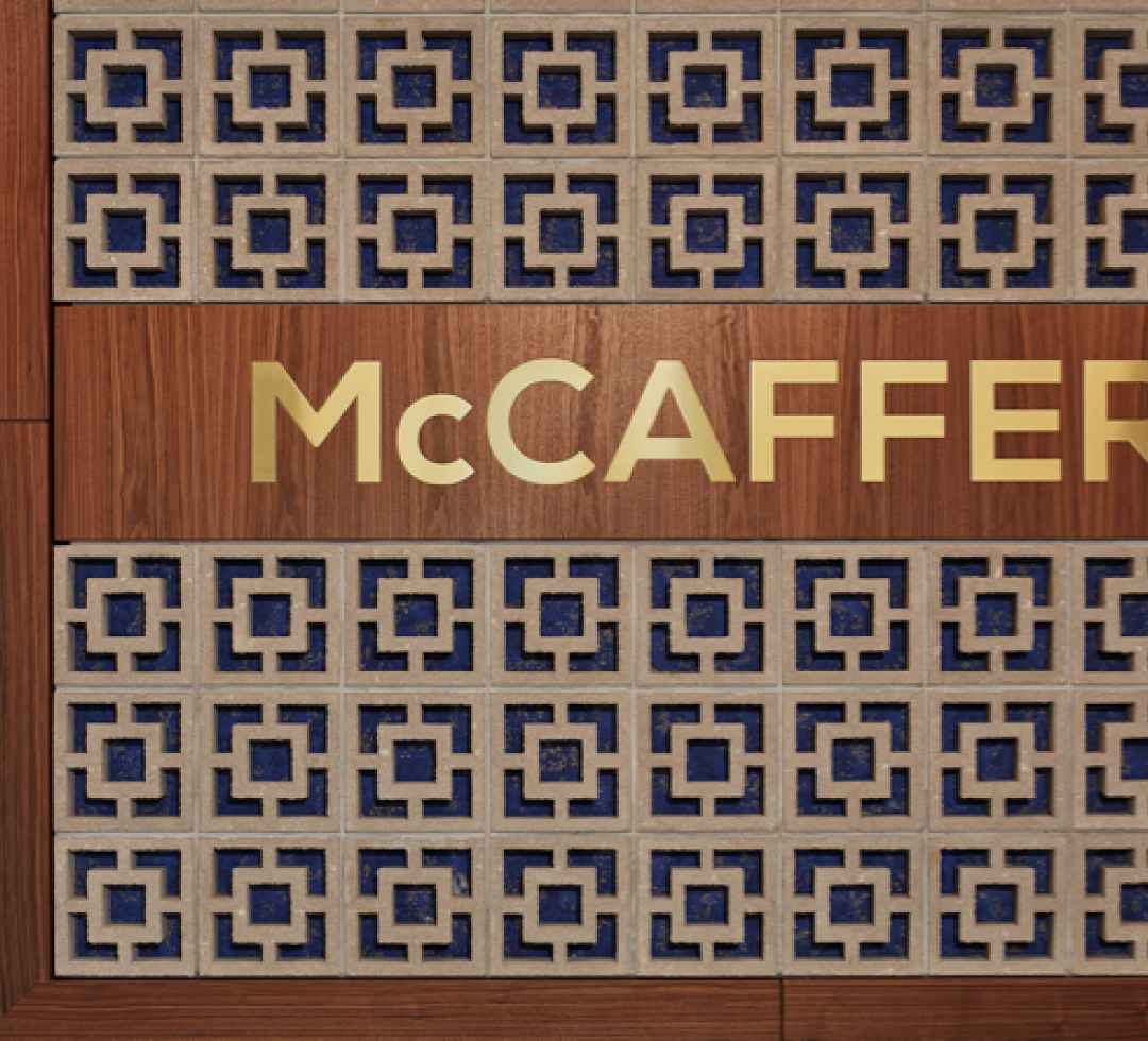 a wooden wall with tile design and the McCaffery logotype in gold